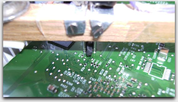 Spring bars pressing against PCB solder pads